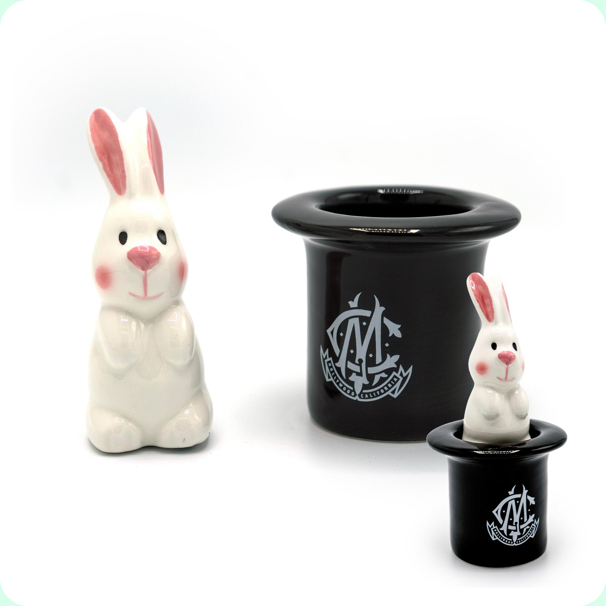 A white ceramic bunny that fits inside of a black ceramic top hat.