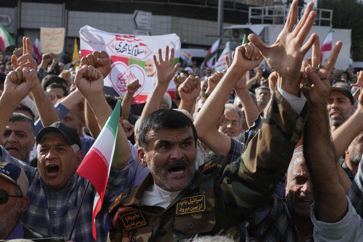 Protesters in Tehran chant slogans Sunday in a protest after the U.S. attacks on nuclear sites in Iran.