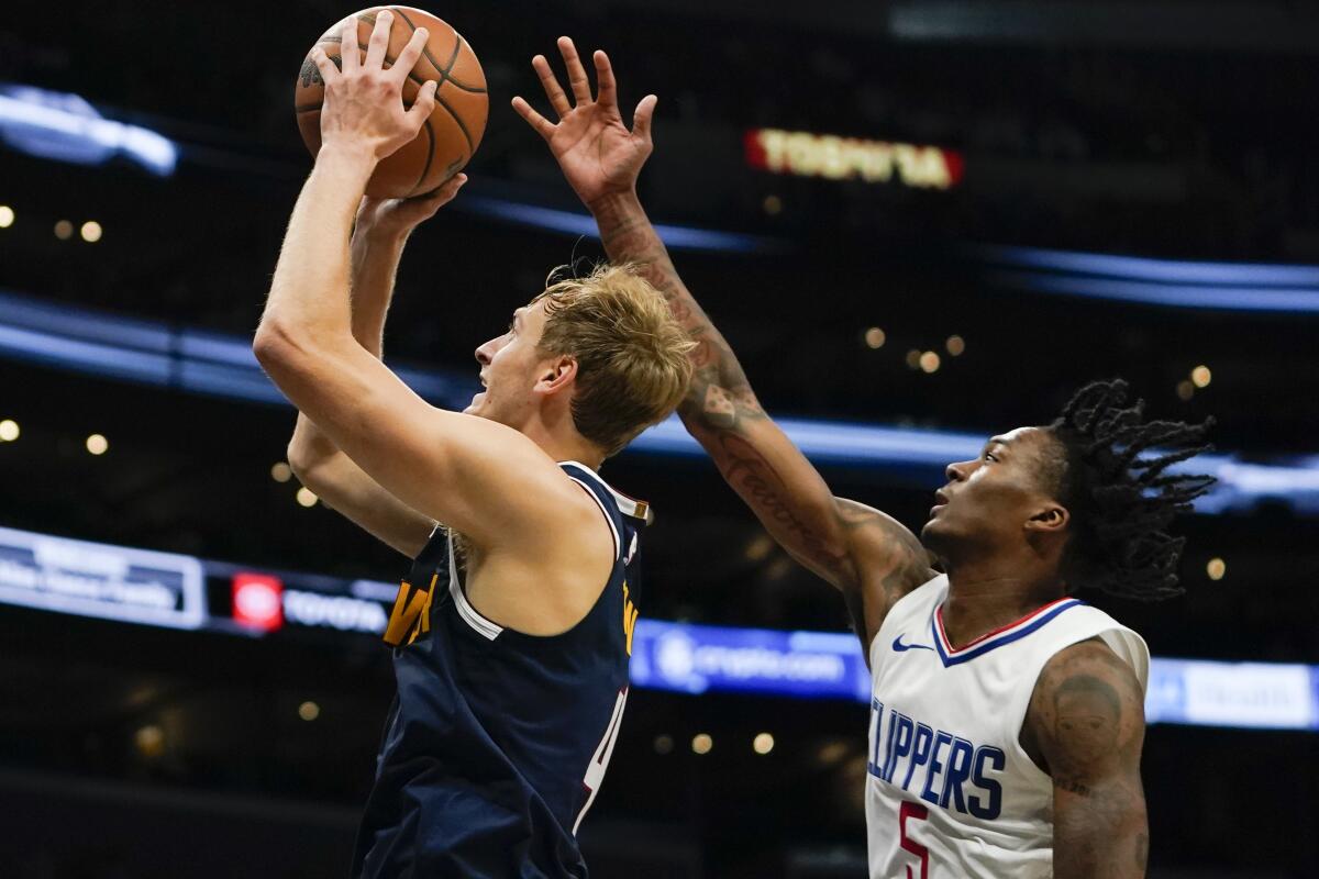 Denver Nuggets forward Hunter Tyson shoots as Clippers guard Bones Hyland defends.
