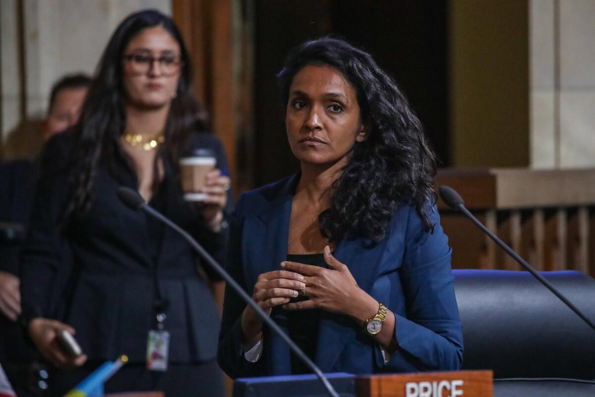 A woman in a suit at a microphone