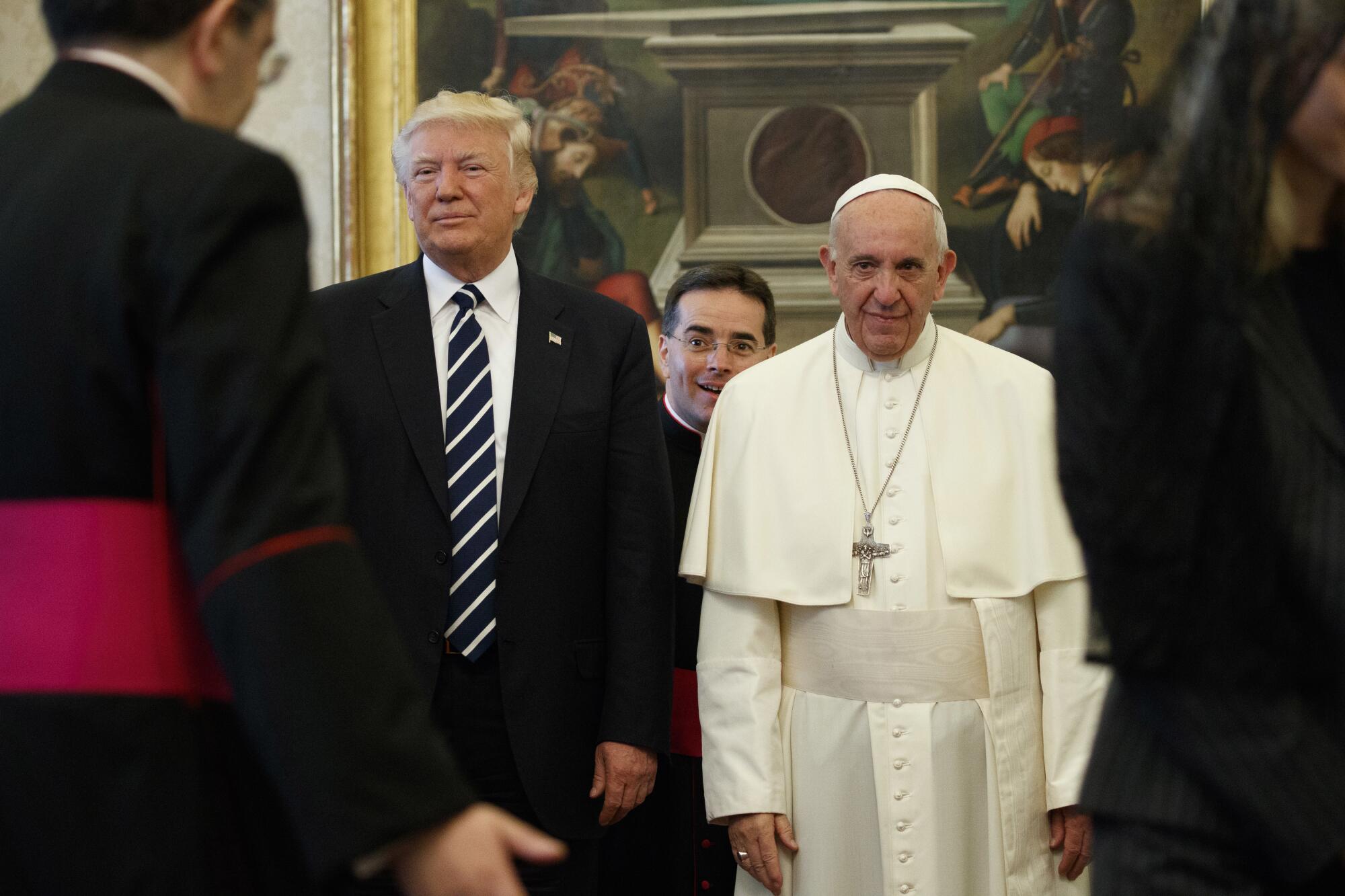 President Trump stands next to Pope Francis.