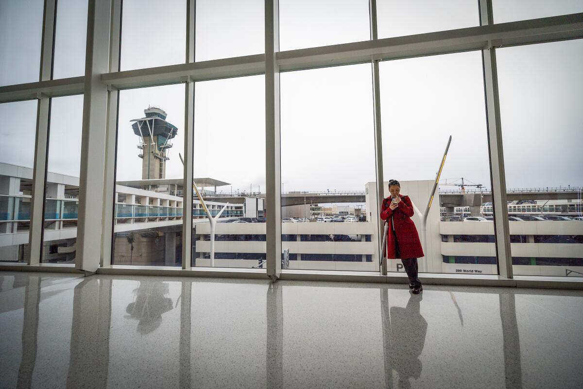 A traveler waiting inside the Delta Airlines terminal at Los Angeles International Airport