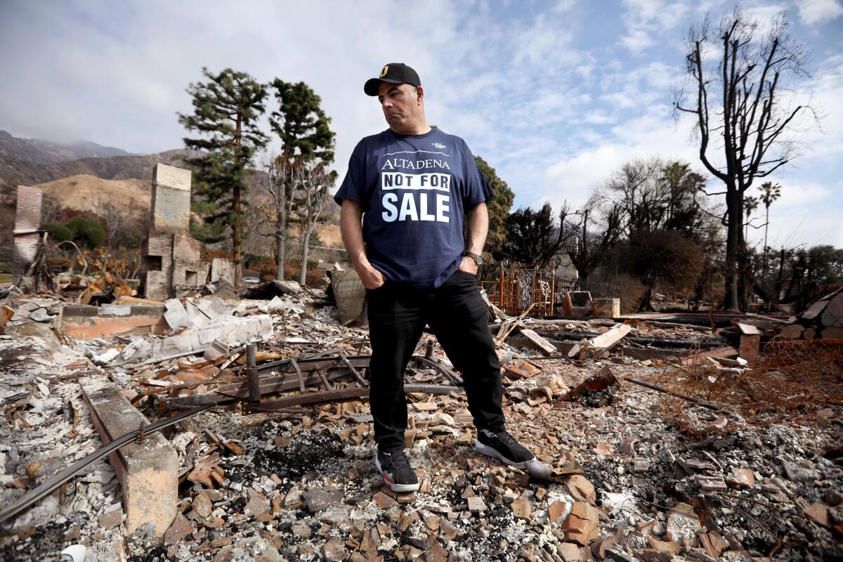 Photo of a man standing on top of a pile of rubble.