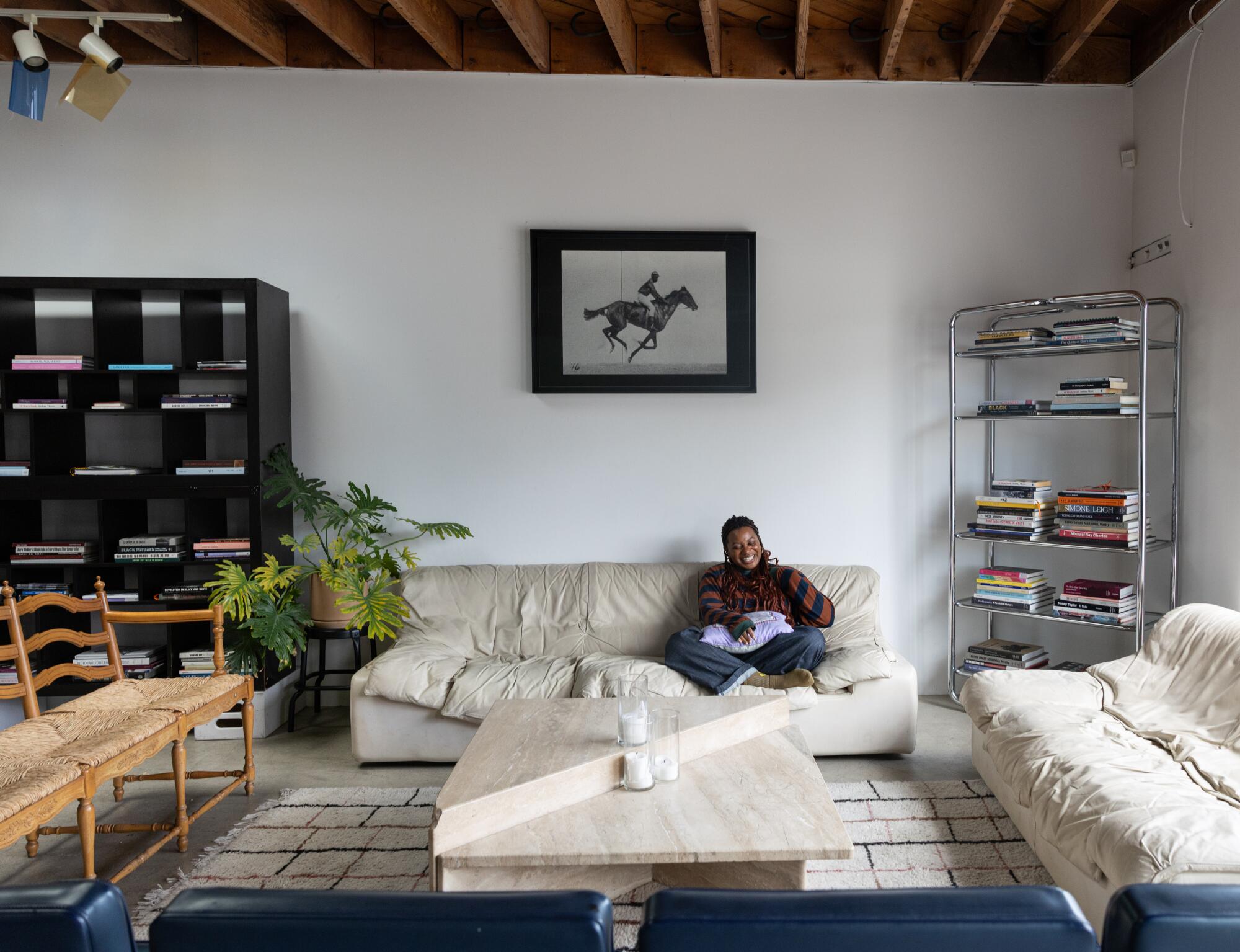 A person sits on a sofa in the reading nook.