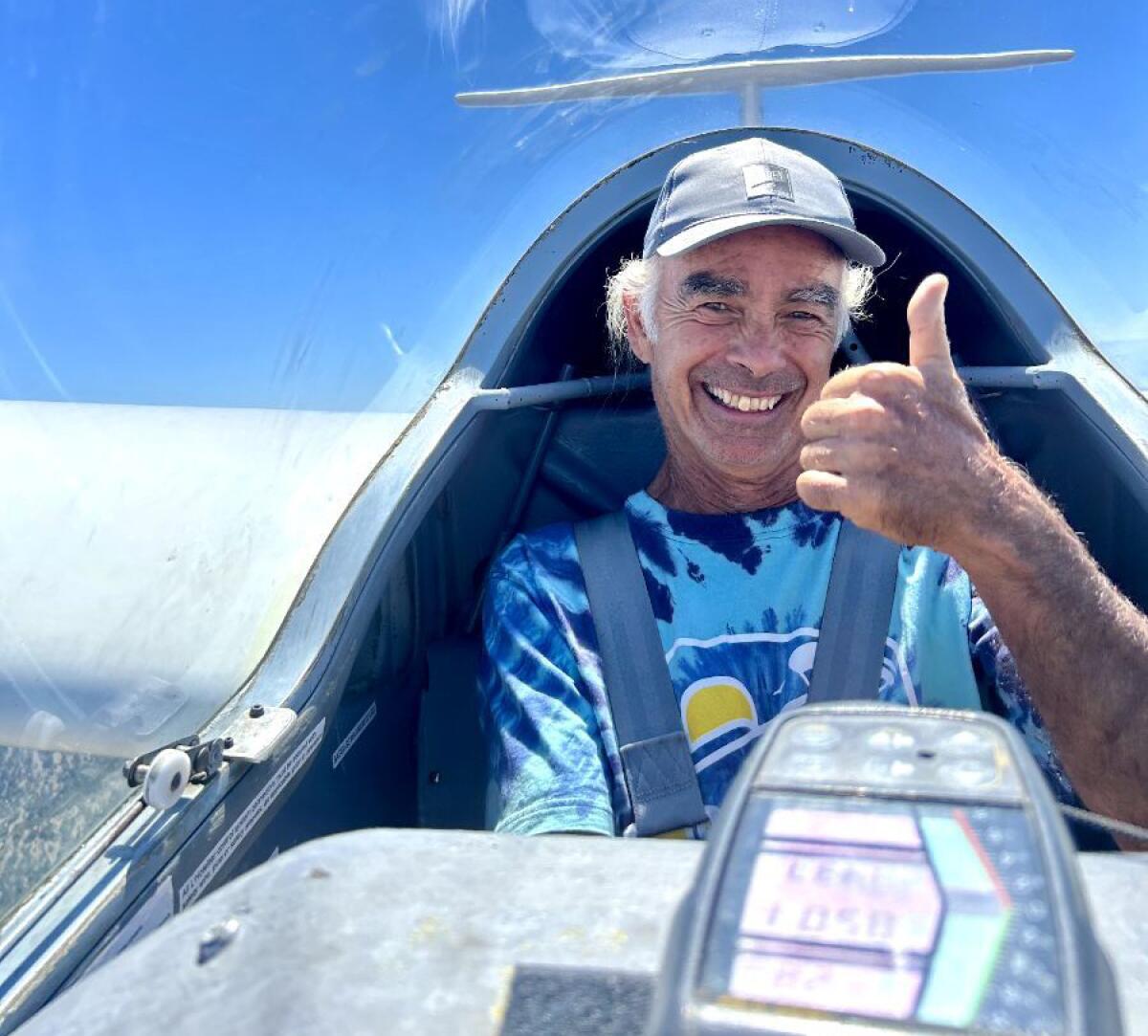 Arthur Simoneau signals a thumbs-up while gliding