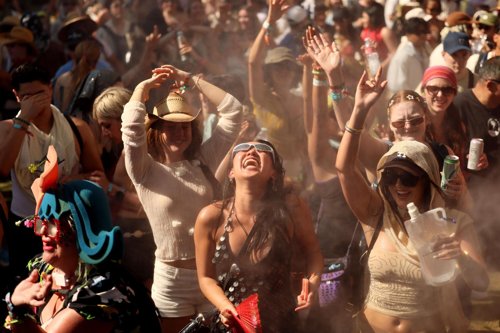 Music fans soaking up sprays from a water cannon