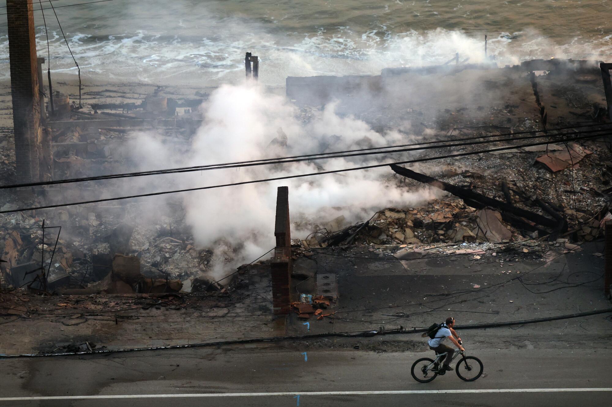 Houses smolder from the Palisades fire in Malibu.