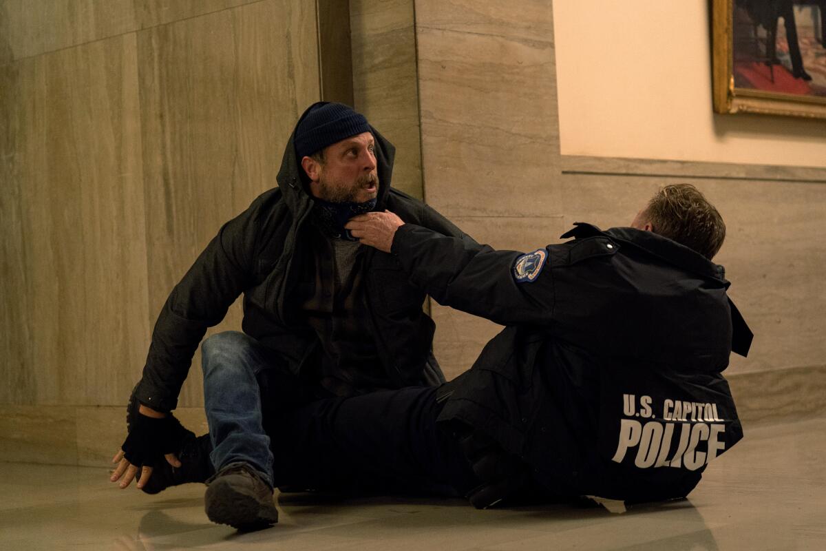 An actor on "The Morning Show" in a scene recreating the Jan. 6 attack on the U.S. Capitol