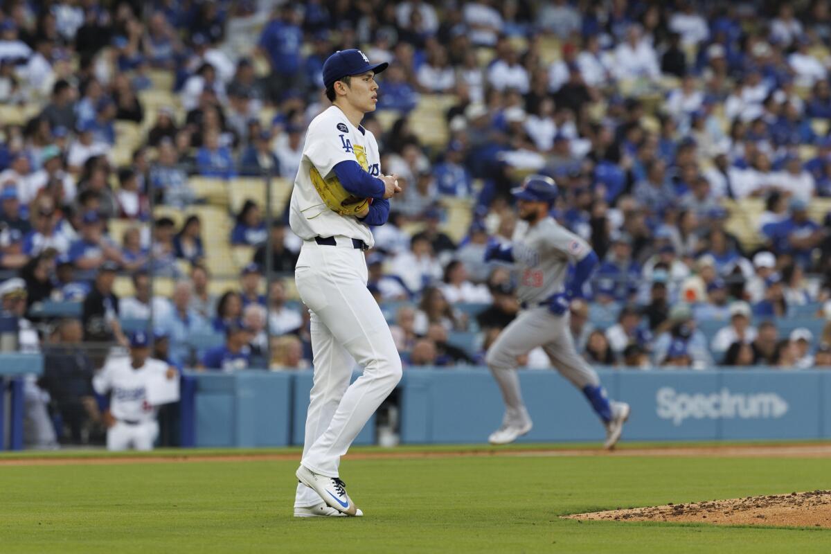 Roki Sasaki walks to the mound.