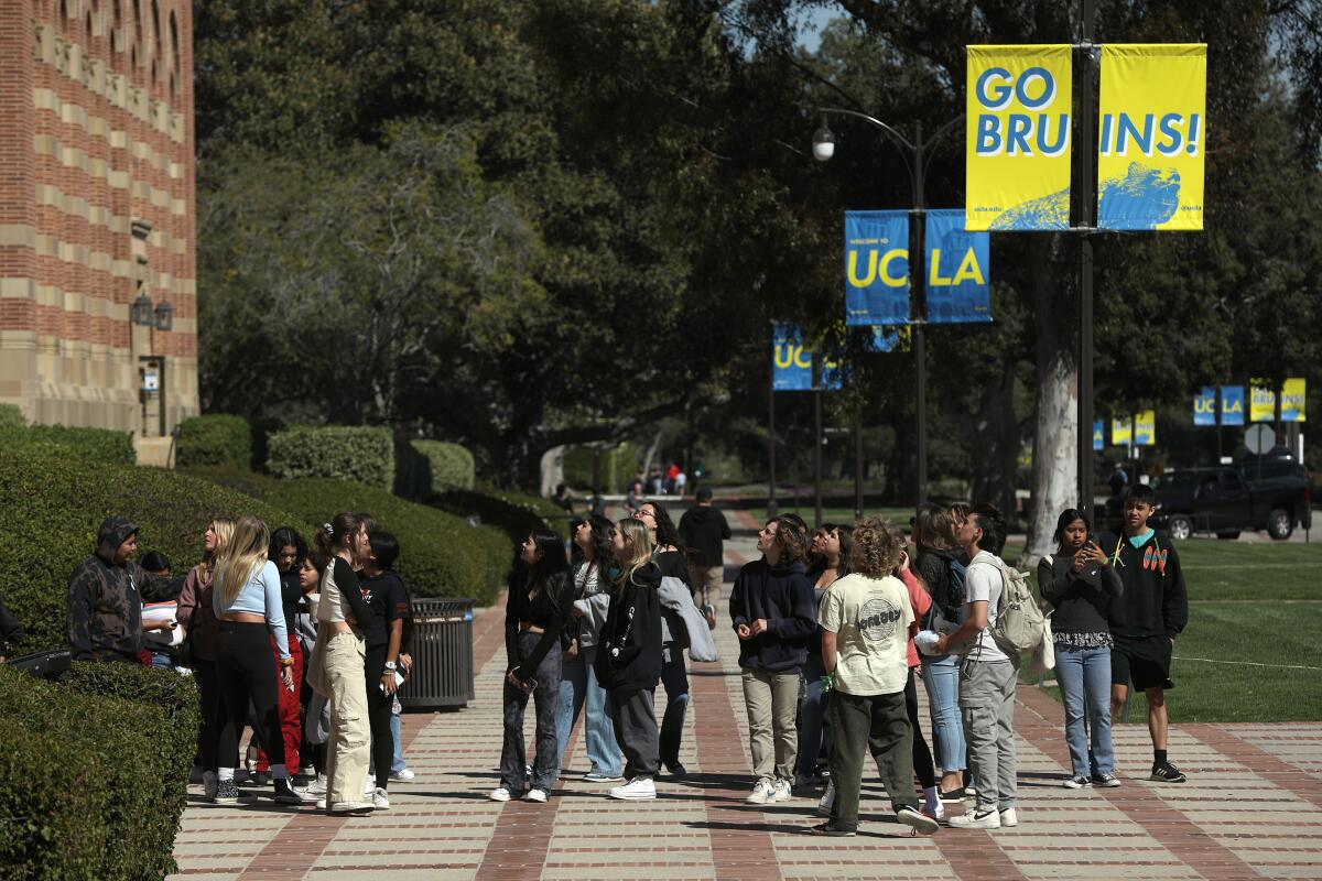 Young people pass by Royce Hall at UCLA.