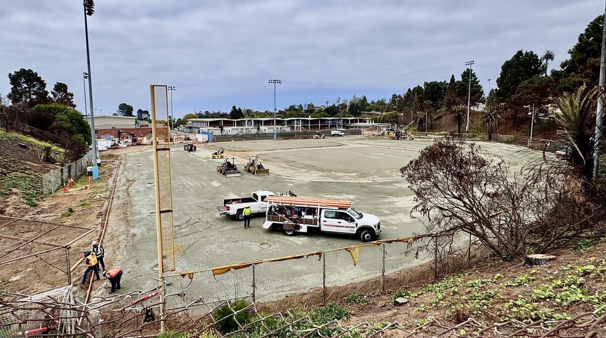 Construction workers and their equipment can be seen on what had been Palisades High's baseball field.