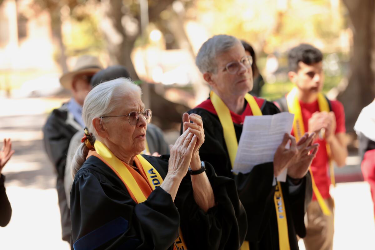 Two faculty members at a rally