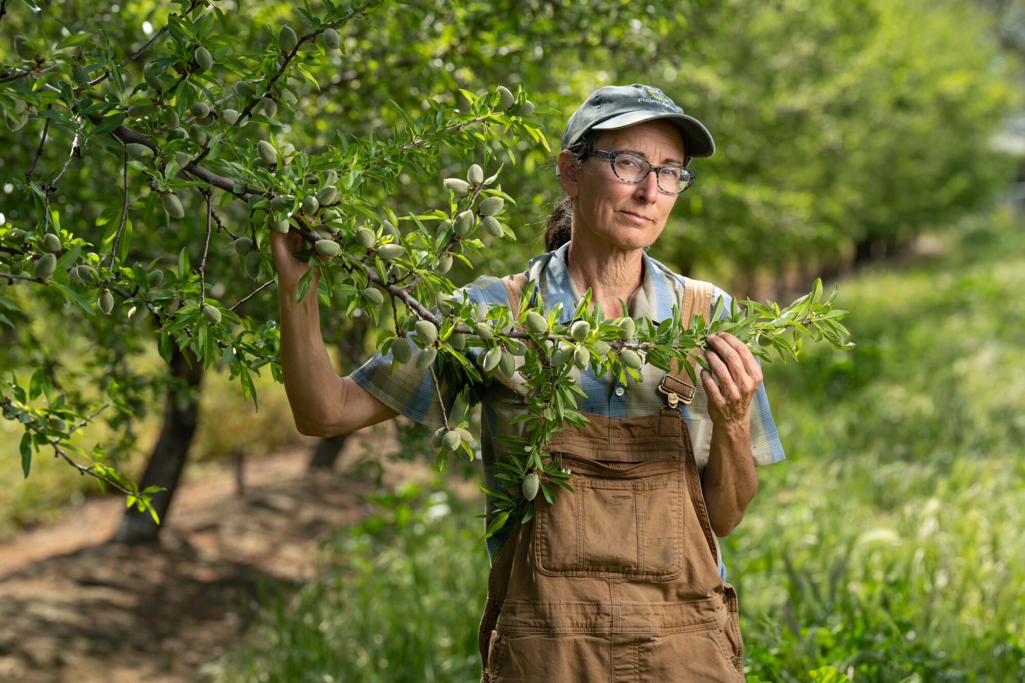 Christine Gemperle stands in one of her almond orchards.