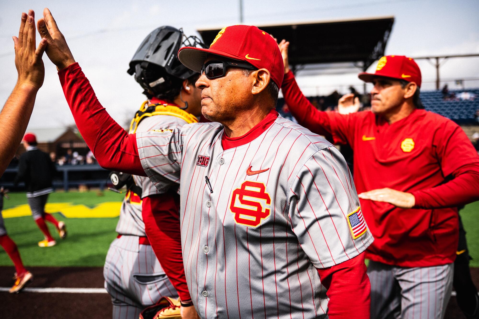 USC baseball coach Andy Stankiewicz high-fives his players after a game earlier this season.